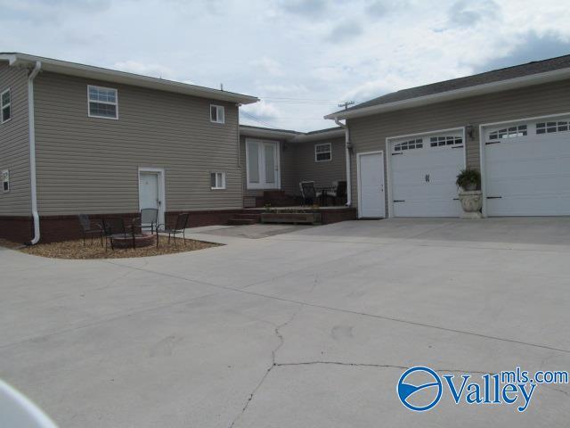 rear view of property with a garage