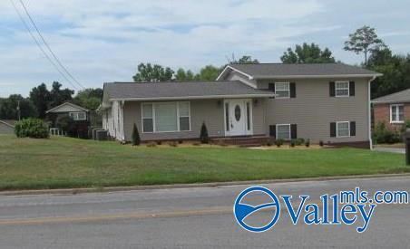 split level home featuring a front lawn