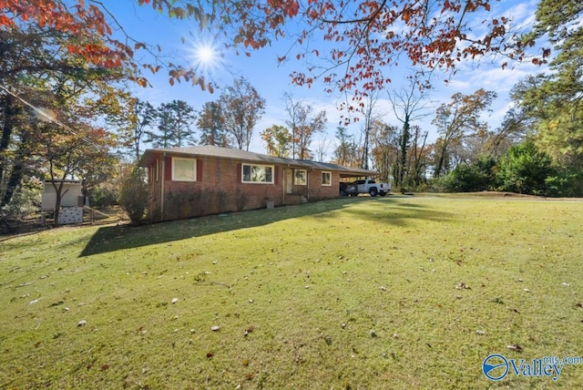 view of front of house with a front lawn and a carport