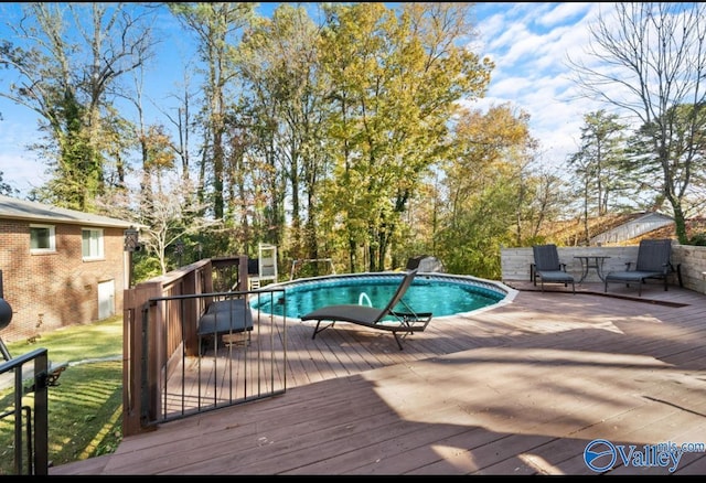 view of swimming pool featuring a wooden deck