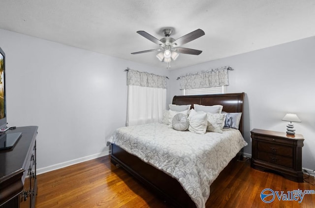 bedroom featuring dark hardwood / wood-style floors and ceiling fan