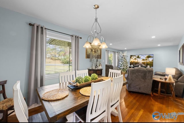 dining area featuring dark hardwood / wood-style flooring and a chandelier