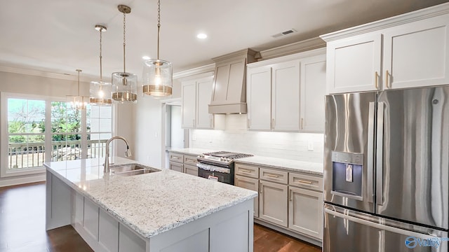 kitchen with a sink, dark wood-type flooring, custom range hood, appliances with stainless steel finishes, and backsplash