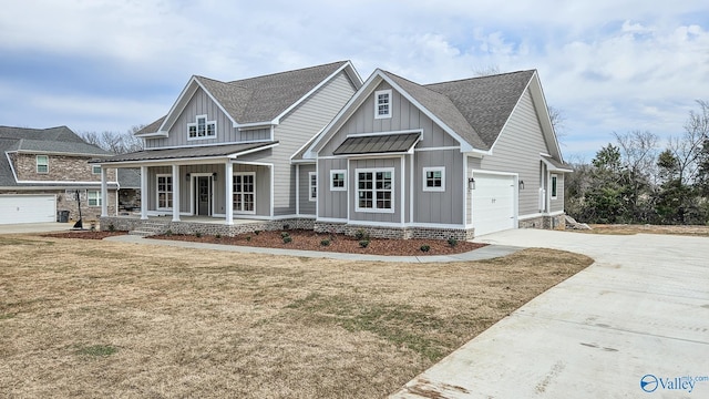 view of front of house with a porch, board and batten siding, concrete driveway, and a front yard