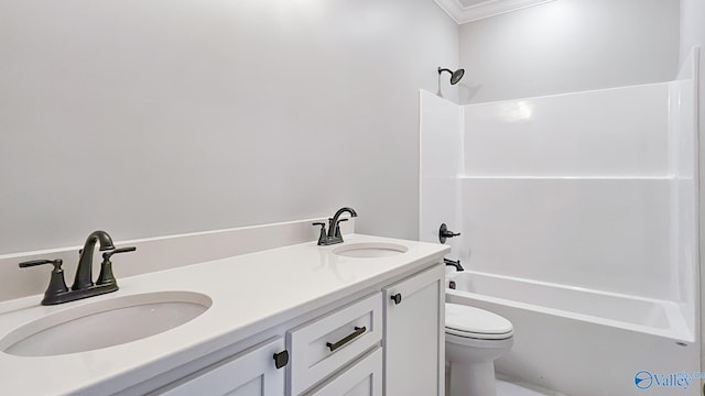 bathroom with double vanity, toilet, bathtub / shower combination, and a sink