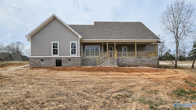 view of front facade featuring a porch and a shingled roof