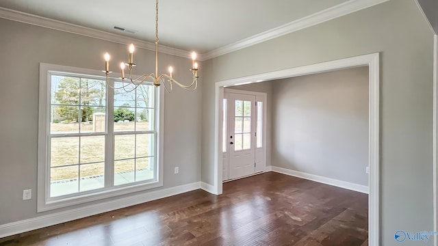 unfurnished dining area featuring visible vents, crown molding, baseboards, dark wood-style floors, and a notable chandelier