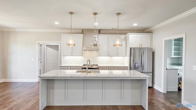 kitchen featuring a kitchen island with sink, stainless steel refrigerator with ice dispenser, ornamental molding, dark wood-style floors, and decorative backsplash