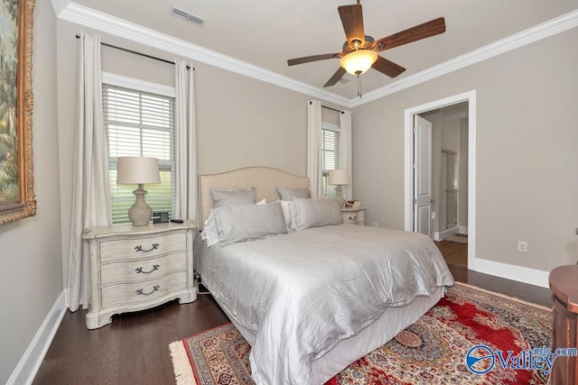 bedroom featuring ornamental molding, dark wood-type flooring, ceiling fan, and ensuite bath