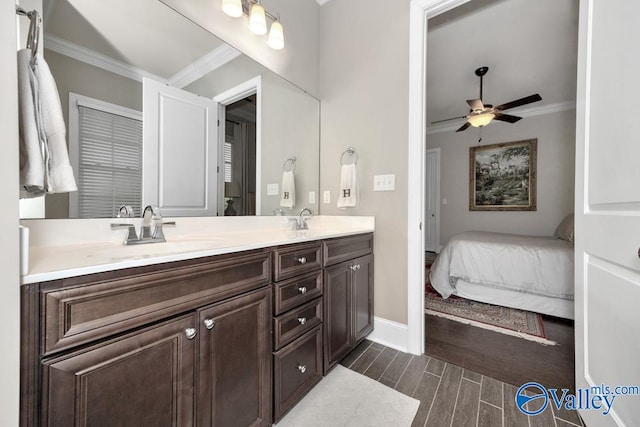 bathroom with ceiling fan, hardwood / wood-style flooring, vanity, and crown molding