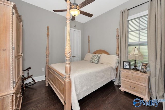 bedroom with dark hardwood / wood-style flooring and ceiling fan