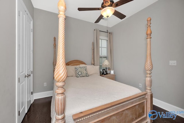 bedroom featuring dark wood-type flooring, ceiling fan, and a closet