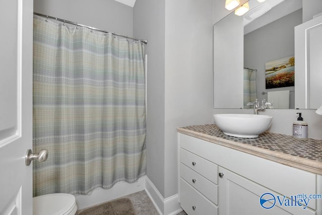 full bathroom featuring shower / bathtub combination with curtain, vanity, and toilet