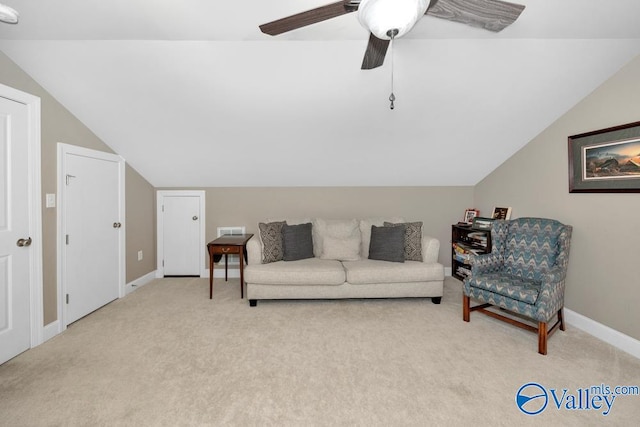 carpeted living room featuring ceiling fan and vaulted ceiling