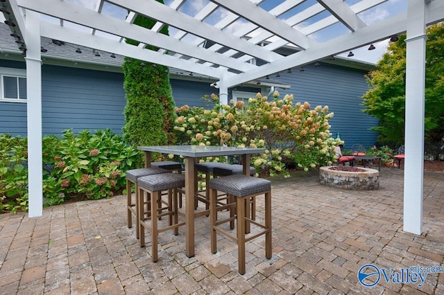 view of patio with a fire pit and a pergola