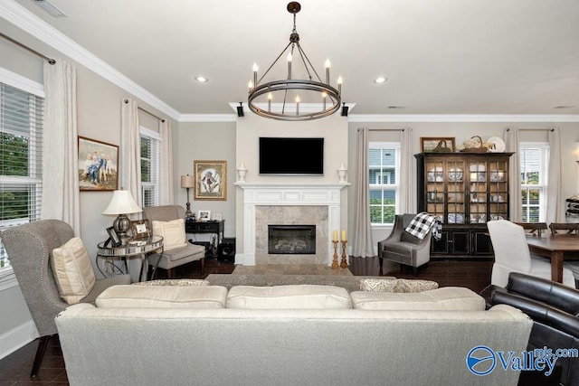 living room with an inviting chandelier, a fireplace, and plenty of natural light