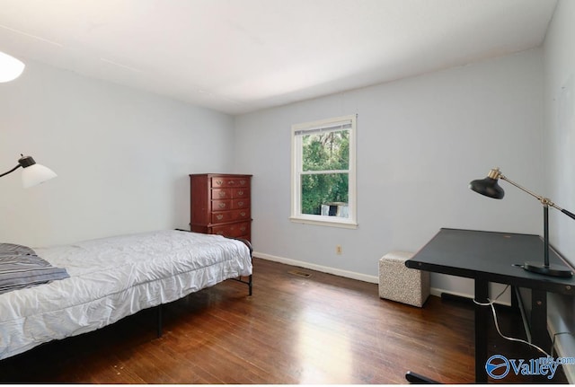 bedroom featuring dark wood-type flooring and baseboards