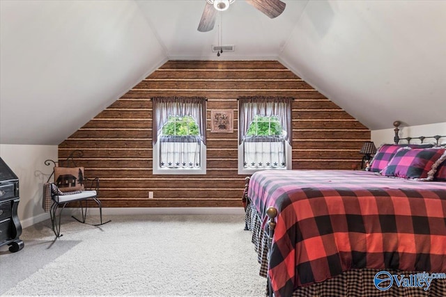1081 County Road 190, Moulton, AL 35650 - carpeted bedroom with wooden walls, vaulted ceiling, ceiling fan, and baseboards