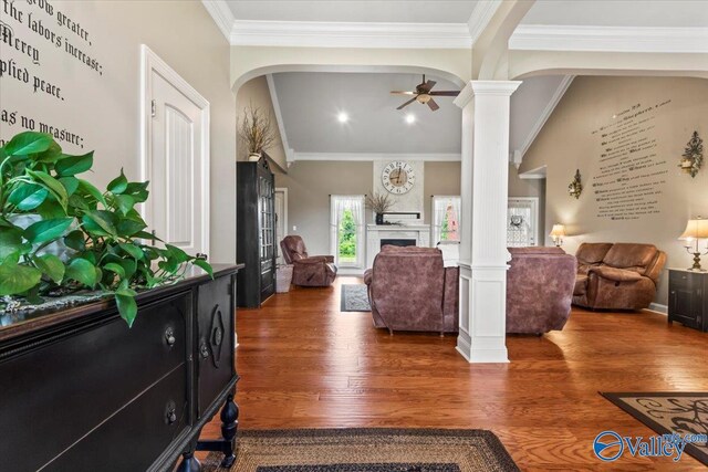 1081 County Road 190, Moulton, AL 35650 - living area with ornate columns, arched walkways, wood finished floors, a fireplace, and ornamental molding