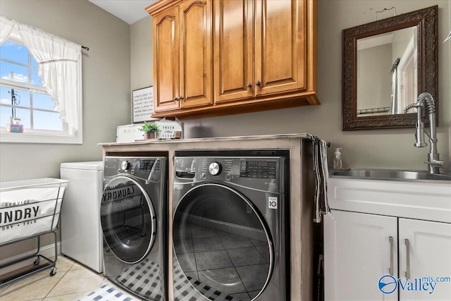 1081 County Road 190, Moulton, AL 35650 - laundry area with washing machine and clothes dryer, cabinet space, and light tile patterned flooring