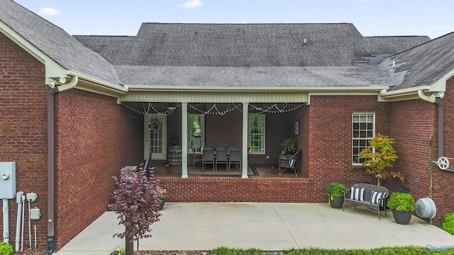1081 County Road 190, Moulton, AL 35650 - property entrance featuring a patio area, a shingled roof, and brick siding