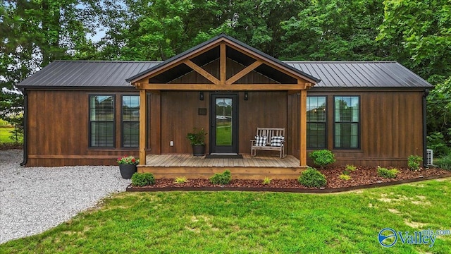 1081 County Road 190, Moulton, AL 35650 - view of front of house featuring metal roof, a front lawn, and covered porch