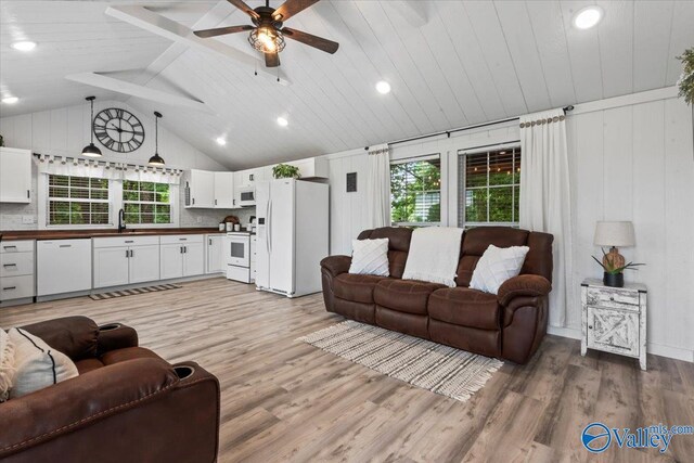 1081 County Road 190, Moulton, AL 35650 - living room with light wood-type flooring, a ceiling fan, wooden ceiling with exposed beams, and high vaulted ceiling