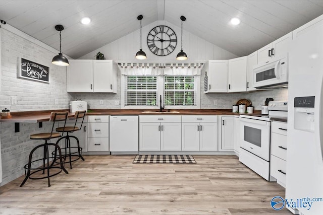 1081 County Road 190, Moulton, AL 35650 - kitchen featuring white appliances, a sink, vaulted ceiling, white cabinets, and butcher block countertops