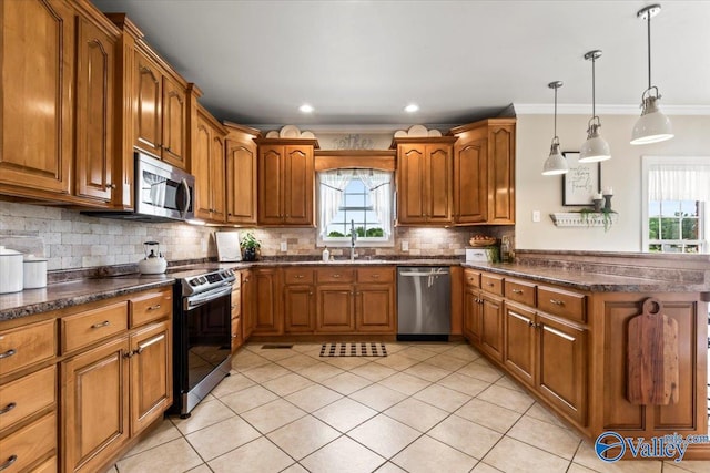 1081 County Road 190, Moulton, AL 35650 - kitchen with appliances with stainless steel finishes, brown cabinets, light tile patterned floors, a peninsula, and tasteful backsplash