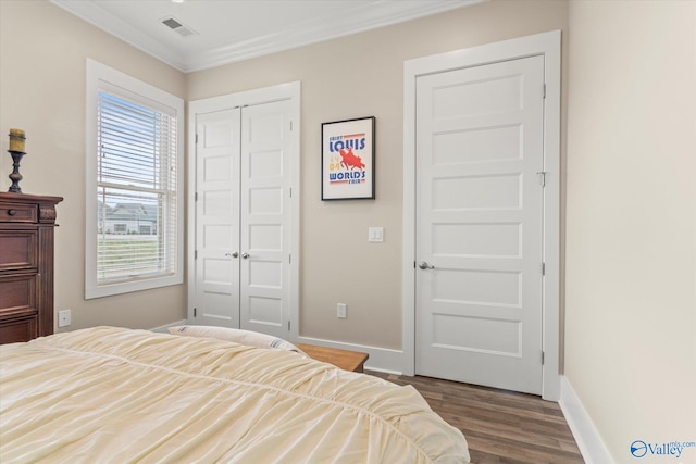 bedroom with crown molding, a closet, and wood-type flooring