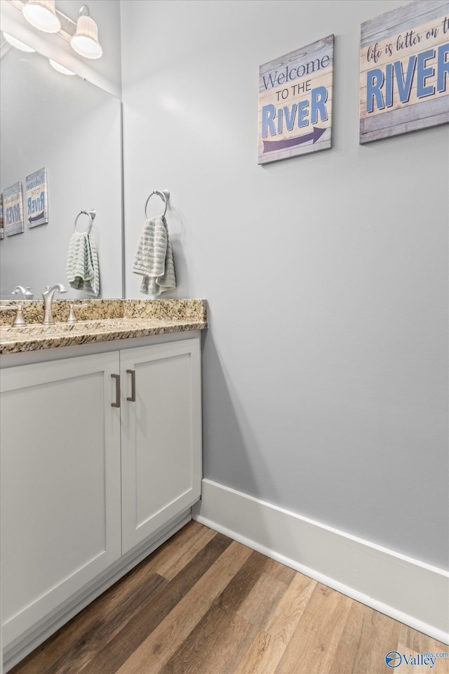 bathroom featuring hardwood / wood-style floors and vanity