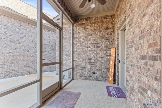 unfurnished sunroom featuring ceiling fan