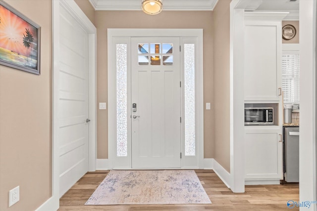 foyer with crown molding and light hardwood / wood-style flooring