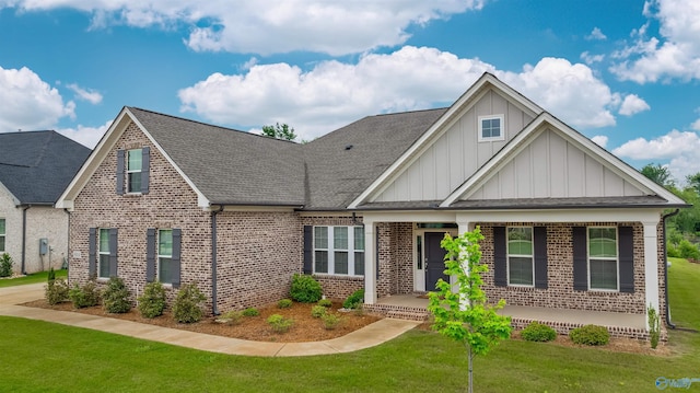 8014 Tupelo Gum Trce SW, Huntsville, AL 35802 - craftsman-style home featuring board and batten siding, brick siding, covered porch, a front yard, and roof with shingles