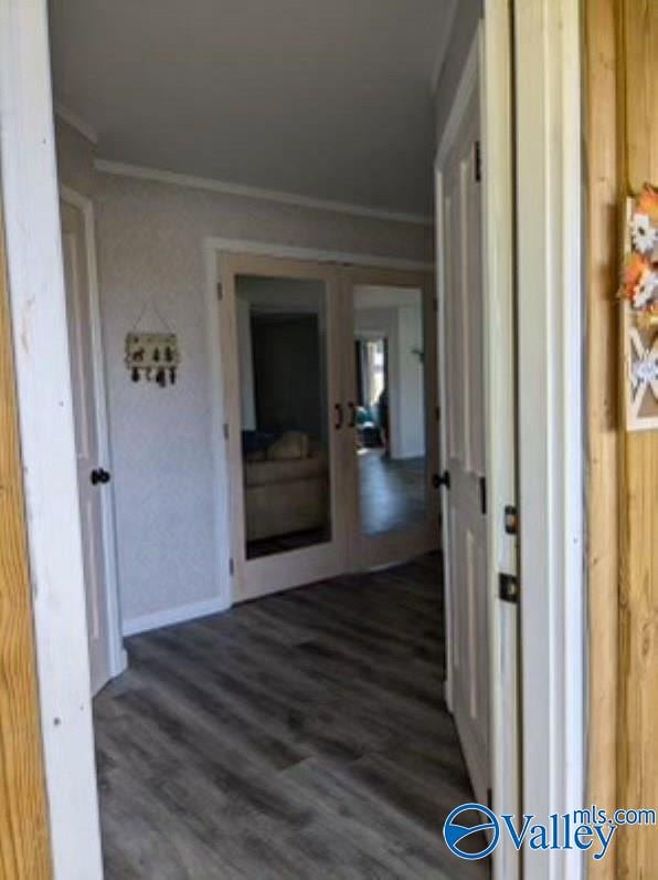 hallway with ornamental molding and dark wood-type flooring