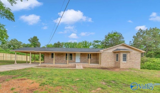 1492 County Road 314, Town Creek, AL 35672 - ranch-style home with a porch, brick siding, concrete driveway, and an attached carport