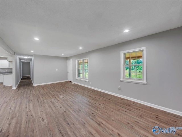 1492 County Road 314, Town Creek, AL 35672 - unfurnished living room with baseboards, light wood finished floors, and recessed lighting