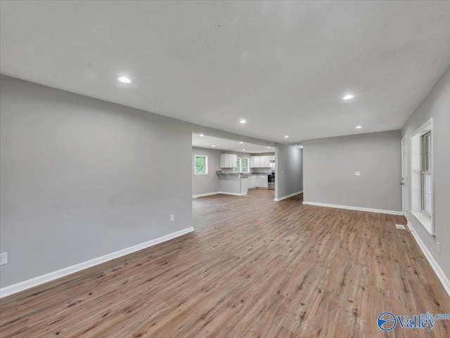 1492 County Road 314, Town Creek, AL 35672 - unfurnished living room featuring recessed lighting, light wood-type flooring, and baseboards