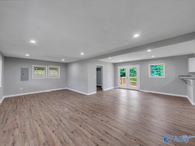 1492 County Road 314, Town Creek, AL 35672 - unfurnished living room featuring recessed lighting, wood finished floors, healthy amount of natural light, and baseboards