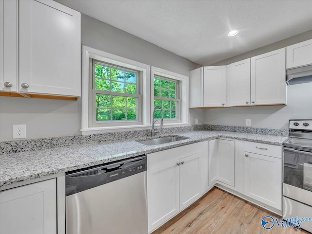 1492 County Road 314, Town Creek, AL 35672 - kitchen with appliances with stainless steel finishes, a sink, light wood-style flooring, white cabinetry, and recessed lighting