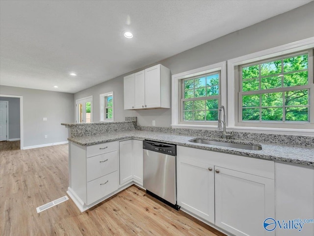 1492 County Road 314, Town Creek, AL 35672 - kitchen with dishwasher, a sink, light wood-style flooring, white cabinets, and a peninsula