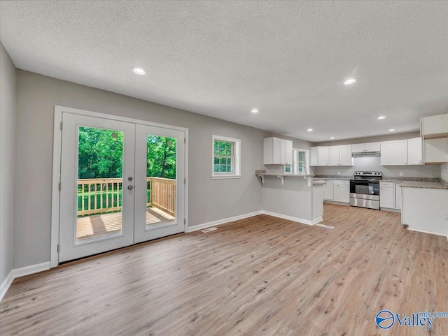 1492 County Road 314, Town Creek, AL 35672 - kitchen featuring electric stove, light wood-style flooring, french doors, baseboards, and a textured ceiling