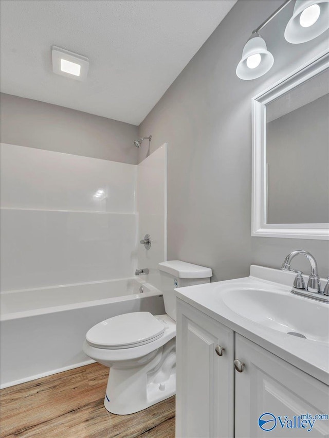 1492 County Road 314, Town Creek, AL 35672 - full bath featuring wood finished floors, toilet, shower / washtub combination, and vanity