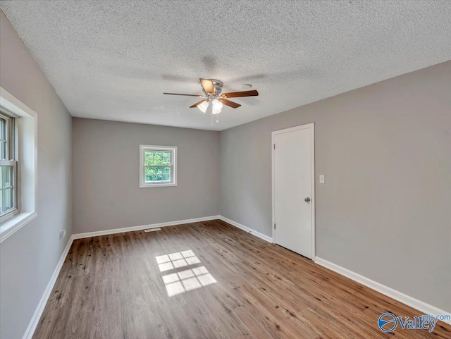 1492 County Road 314, Town Creek, AL 35672 - spare room with ceiling fan, wood finished floors, a textured ceiling, and baseboards