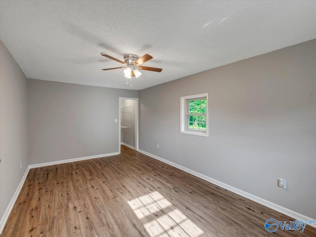 1492 County Road 314, Town Creek, AL 35672 - unfurnished room featuring a ceiling fan, wood finished floors, baseboards, and a textured ceiling