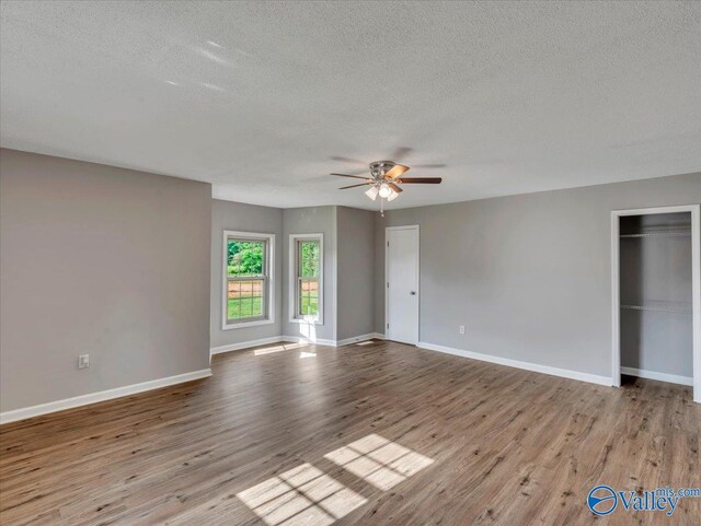 1492 County Road 314, Town Creek, AL 35672 - empty room featuring a textured ceiling, ceiling fan, wood finished floors, and baseboards