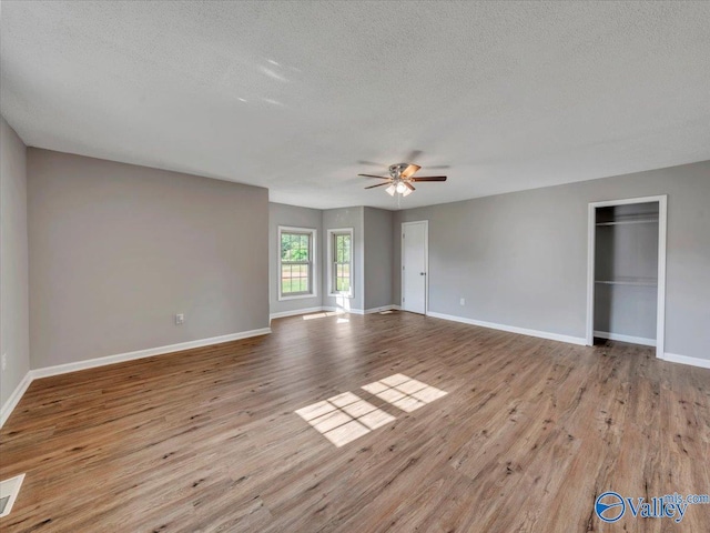 1492 County Road 314, Town Creek, AL 35672 - unfurnished bedroom featuring a textured ceiling, wood finished floors, baseboards, and ceiling fan