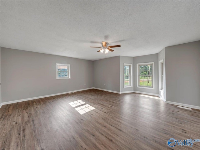 1492 County Road 314, Town Creek, AL 35672 - empty room featuring a ceiling fan, a textured ceiling, wood finished floors, and baseboards