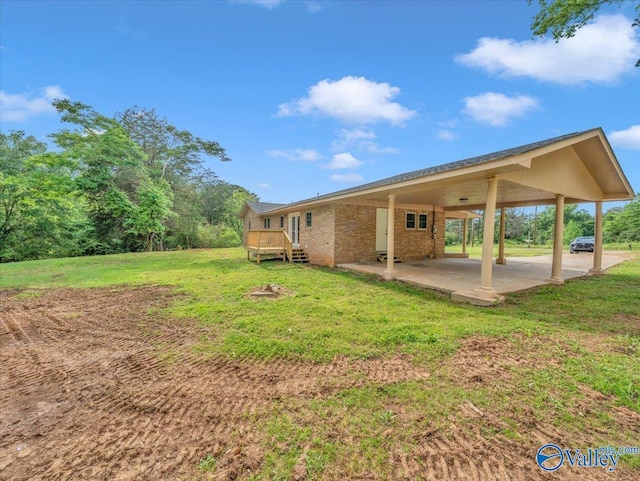 1492 County Road 314, Town Creek, AL 35672 - view of grassy yard with a deck and an attached carport