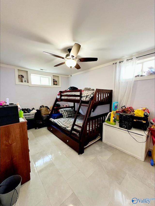 bedroom with multiple windows and ceiling fan